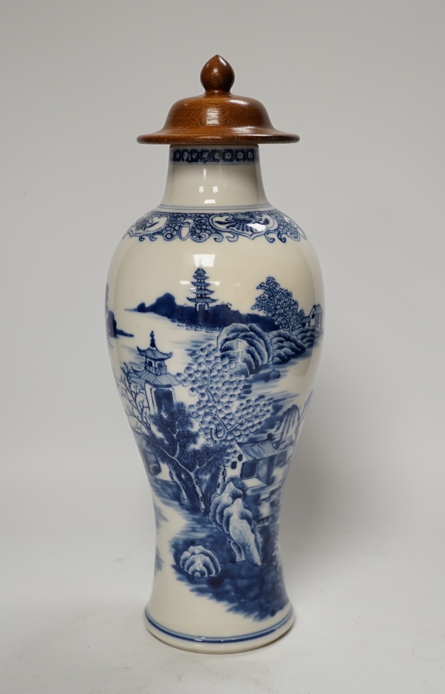 A Chinese Qianlong blue and white vase with wooden cover, 31.5cm